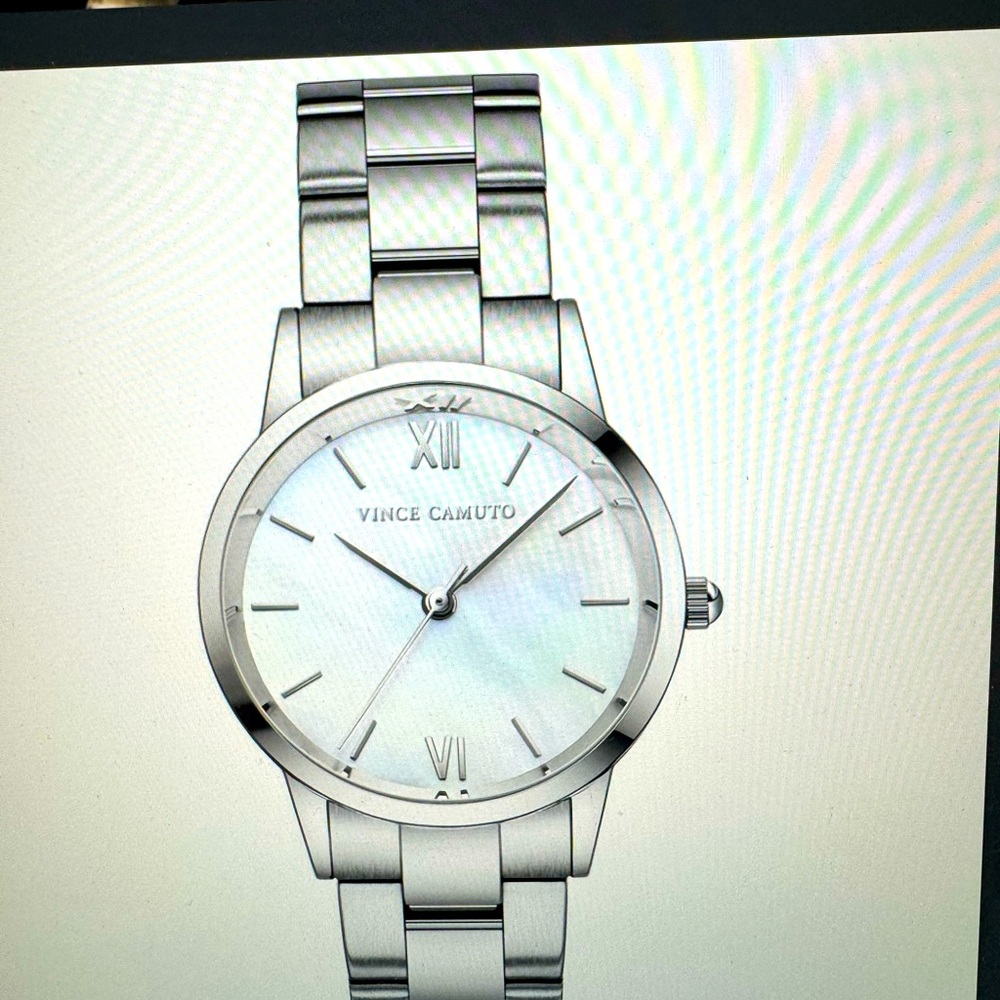 Luxurious stainless steel watch, mother of pearl dial and Roman markers.